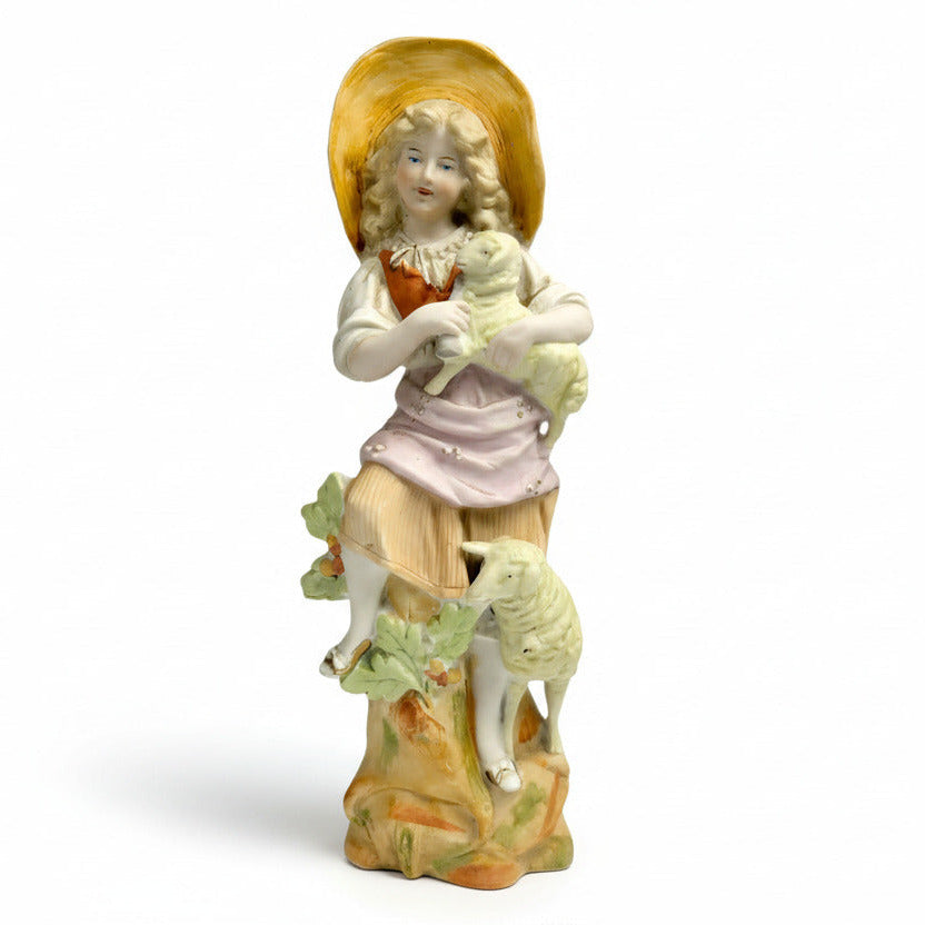 Porcelain figurine of a girl with a lamb on a white background