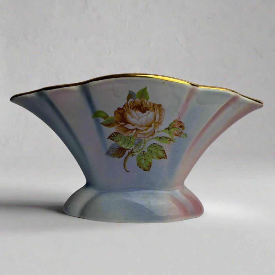 Decorative ceramic vase with floral design on a plain background