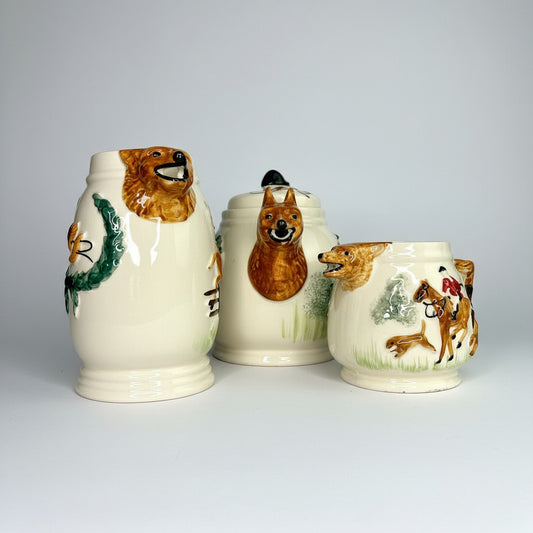 Set of three ceramic containers with animal designs on a white background