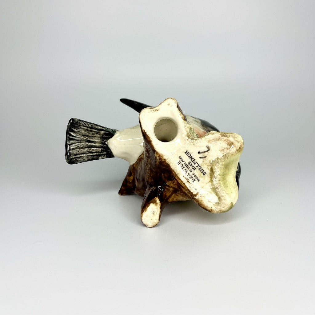 Decorative fish figurine with a white and brown color scheme on a light gray background