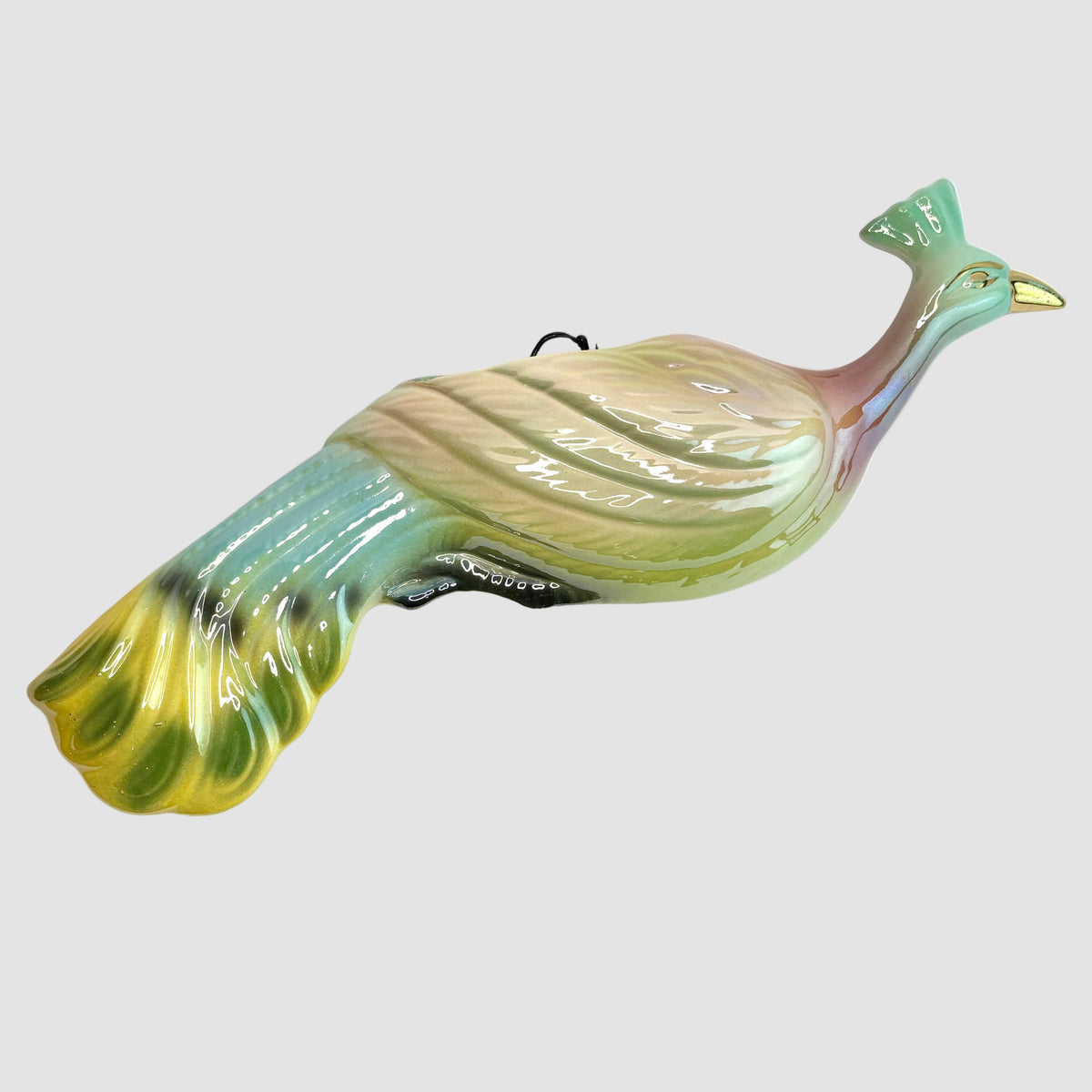 Glass peacock figure on a white background