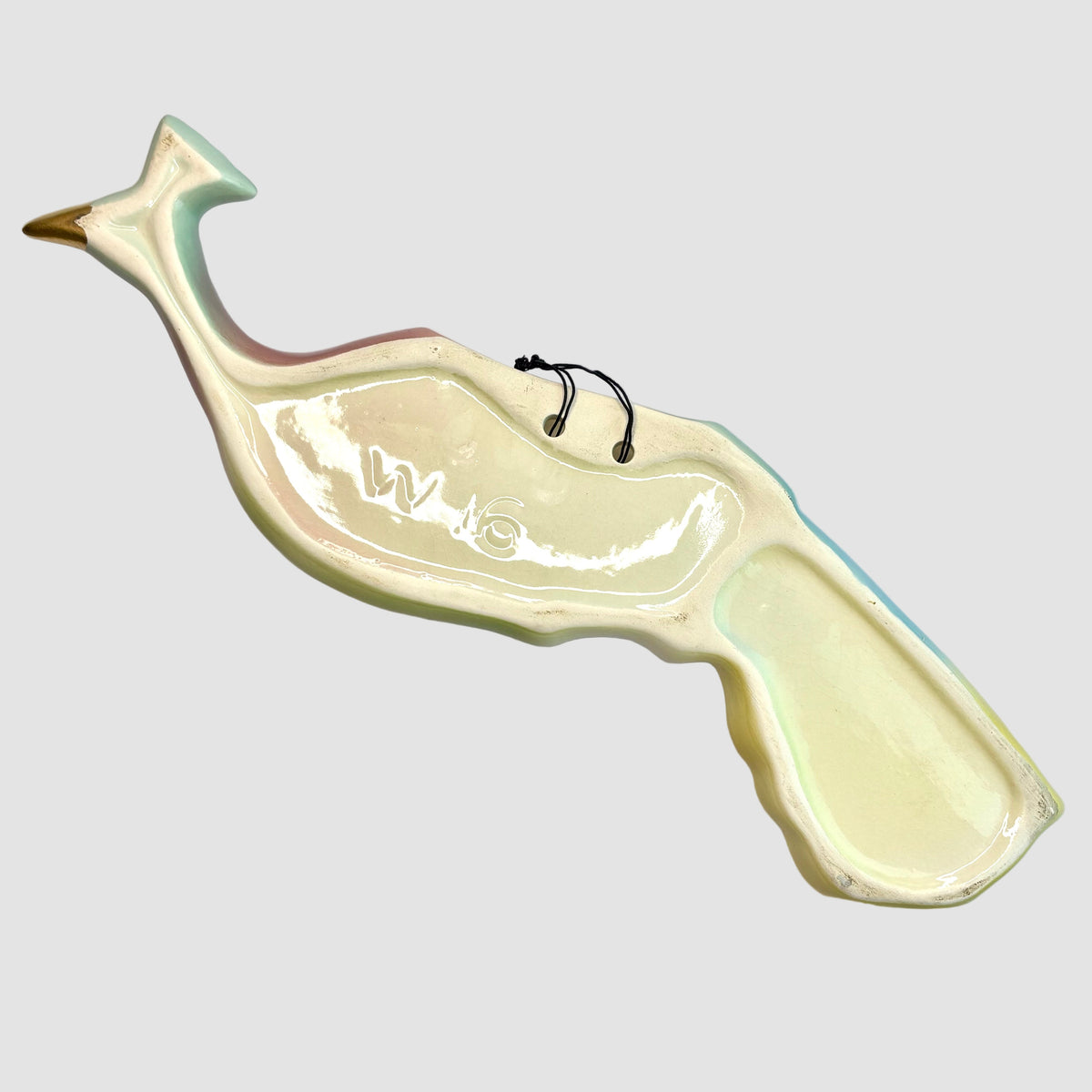 Ceramic whale-shaped platter on a light gray background