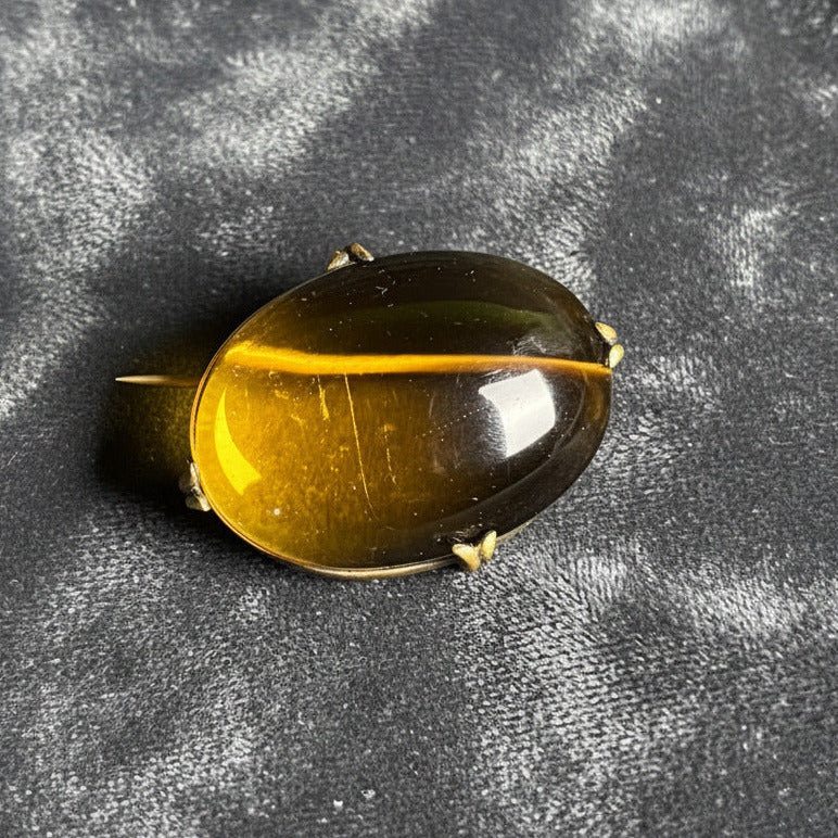 Black and yellow oval-shaped object on a gray surface