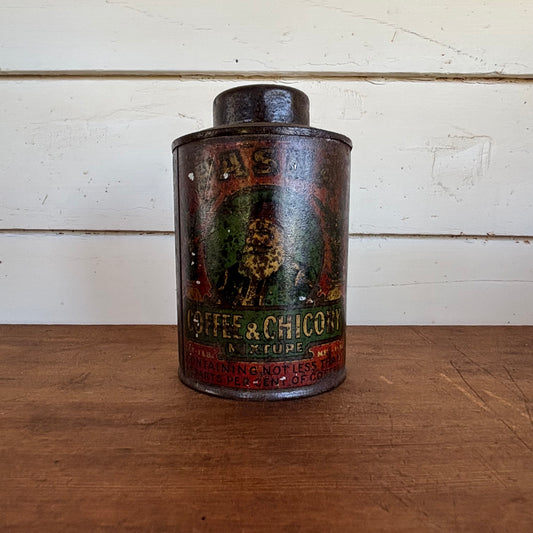 Vintage tin can with coffee and chocolate advertisement on a wooden surface