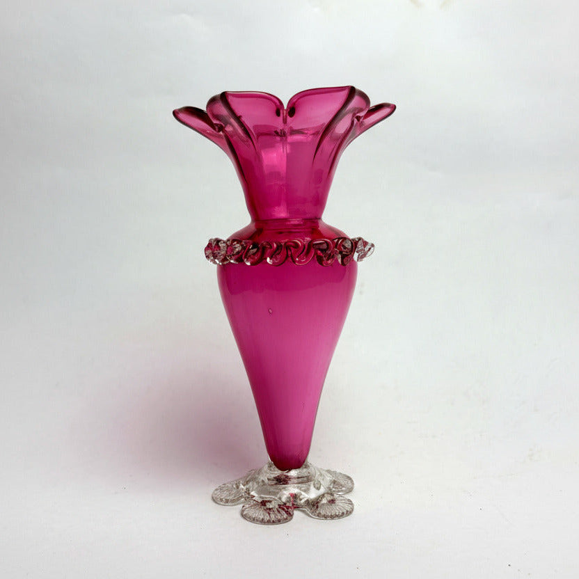 A Victorian cranberry glass vase with a crimped ruffled rim and a base design, displayed against a plain background.
