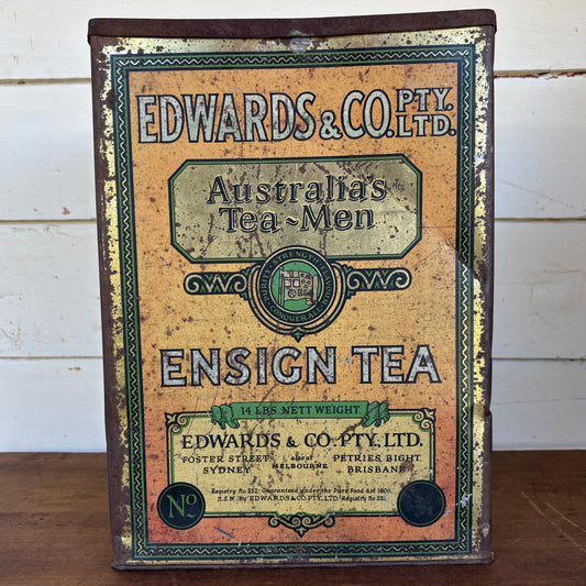 Vintage tea canister with 'Edwards & Co. Pty. Ltd.' branding on a wooden surface.