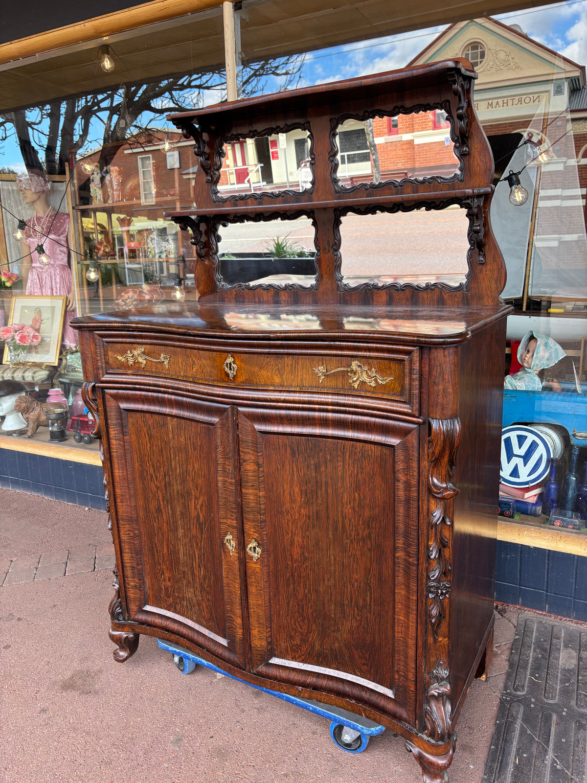 Wooden desk with glass top outdoors on a sunny day
