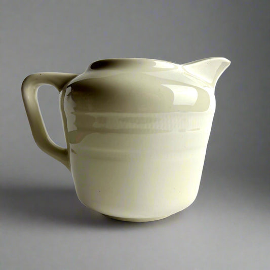 White ceramic pitcher on a light gray background