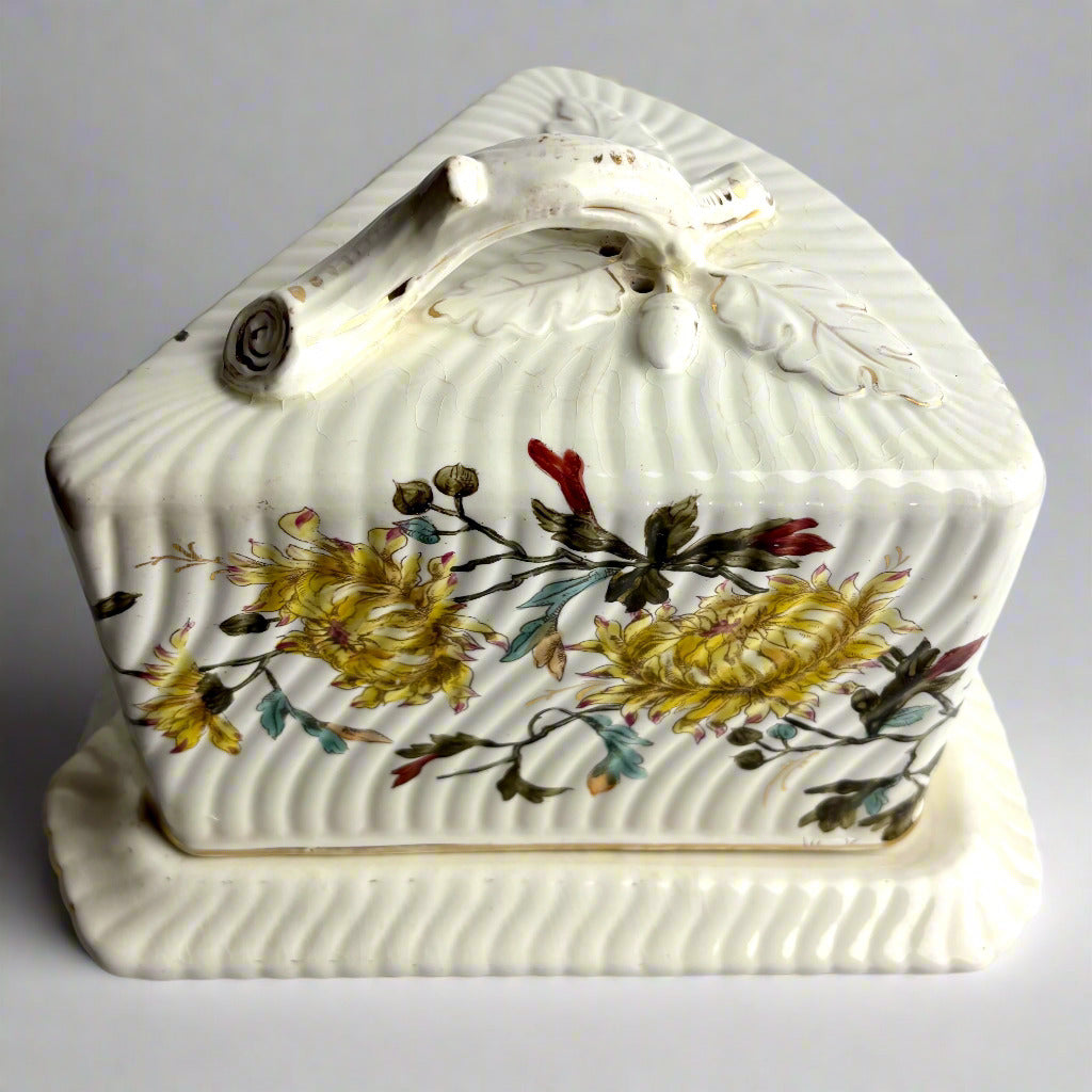 Decorative ceramic shell-shaped object with floral patterns on a gray background