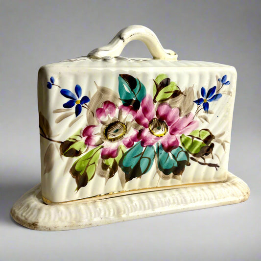 Ceramic butter dish with floral design on a white background