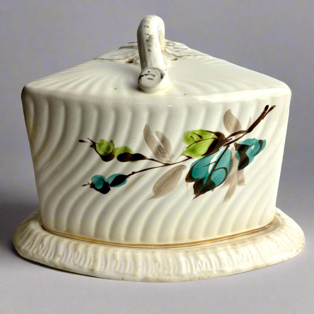 Ceramic butter dish with floral design on a gray background