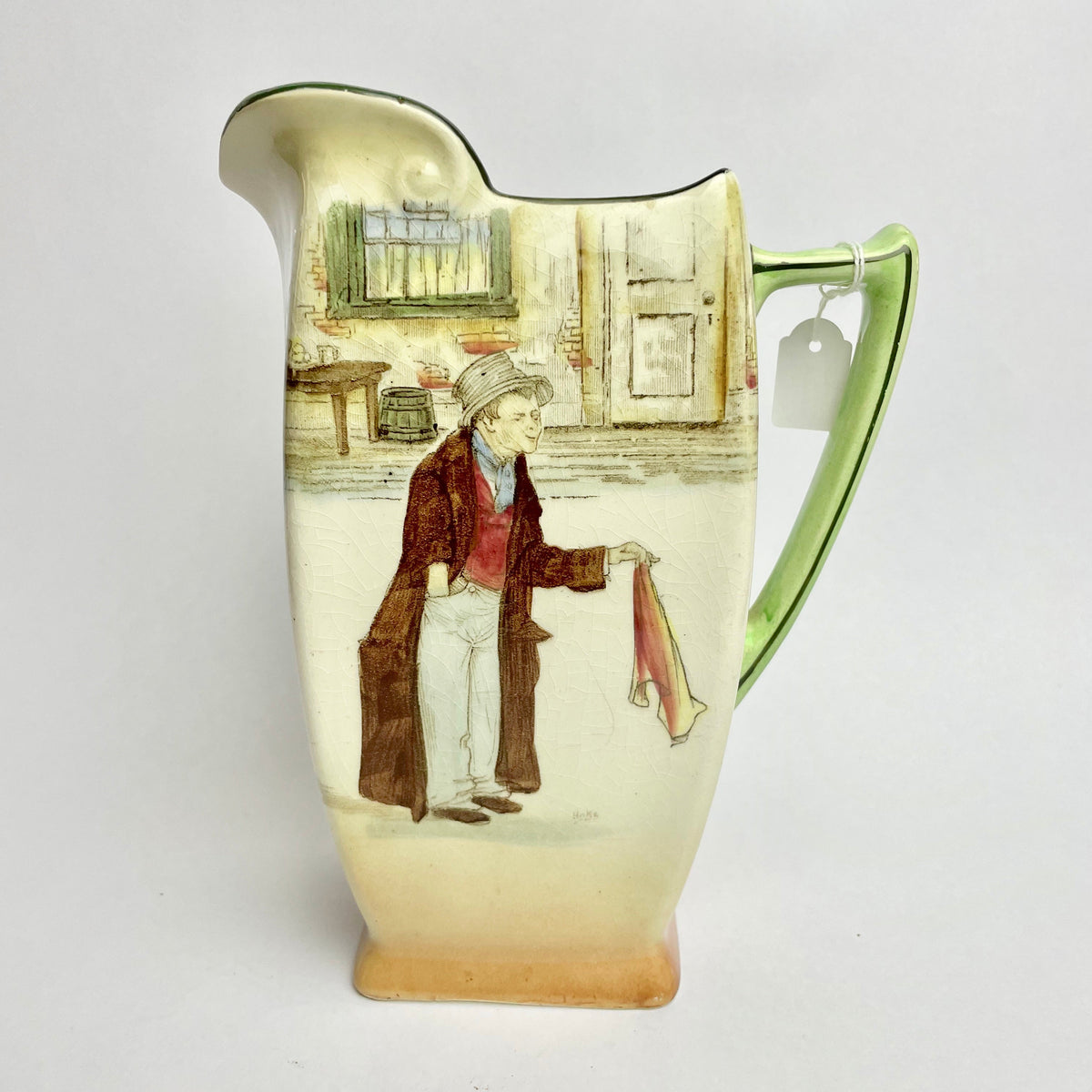 Royal Doulton Dickens Ware The Artful Dodger Jug with a colorful illustration of a character from 'Oliver Twist' on a green background.