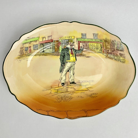 Decorative plate with a painted scene of a man on a street, likely from a vintage or retro design.